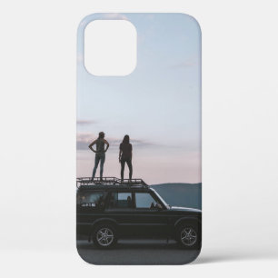 Two women standing on car's roof iPhone 12 case
