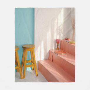 Two yellow wooden bar stools fleece blanket