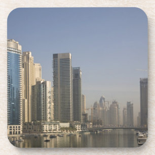 UAE, Dubai. Marina towers with boats at anchor. Coaster