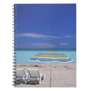 Umbrella and two lounge chairs on beach, Miami Notebook