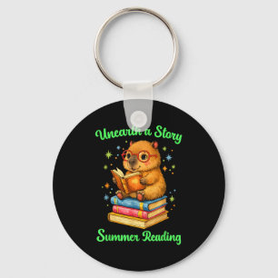 Unearth a story capybara reading books summer key ring