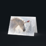 Unicorn Cardinal Christmas Holiday Season Card<br><div class="desc">Unicorn Christmas cards because the holidays are magical!  This is a beautiful image of a Cardinal red bird riding with a Unicorn as it is snowing. A pretty Xmas tree in the background. Send a bit of magical fun with this pretty seasonal holiday card.</div>