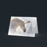 Unicorn Cardinal Christmas Holiday Season Card<br><div class="desc">Unicorn Christmas cards because the holidays are magical!  This is a beautiful image of a Cardinal red bird riding with a Unicorn as it is snowing. A pretty Xmas tree in the background. Send a bit of magical fun with this pretty seasonal holiday card.</div>