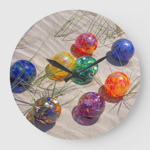 USA, Oregon. Colourful Glass Floats On Sand Dune Large Clock