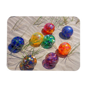 USA, Oregon. Colourful Glass Floats On Sand Dune Magnet