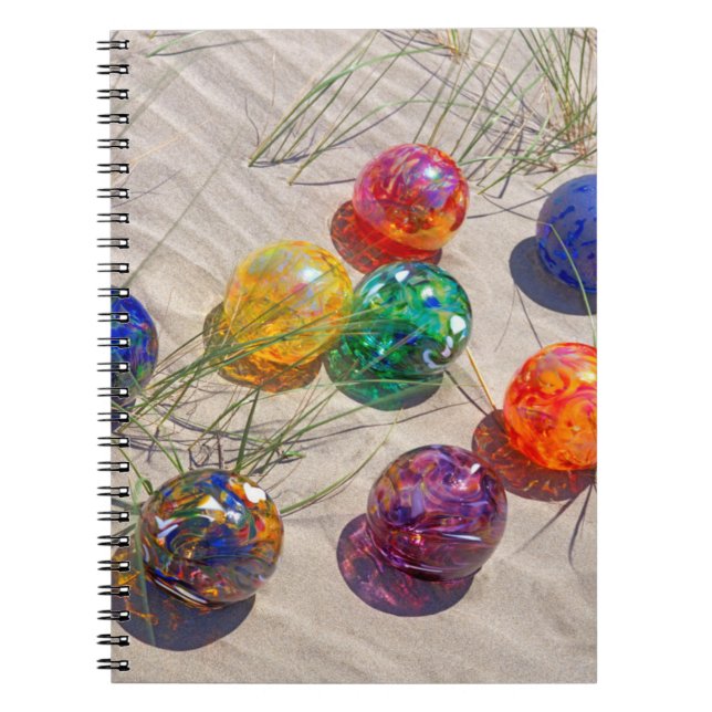 USA, Oregon. Colourful Glass Floats On Sand Dune Notebook (Front)