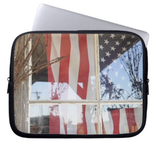 USA, Oregon, Shaniko. Flag in window next to Laptop Sleeve
