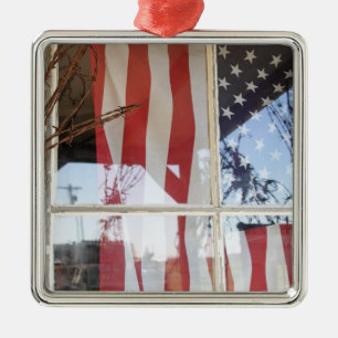 USA, Oregon, Shaniko. Flag in window next to Metal Tree Decoration