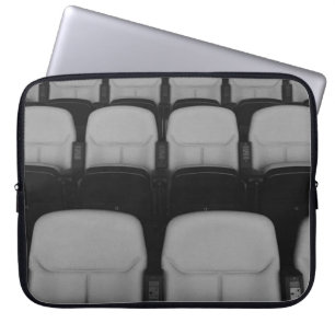 VACANT WHITE AND BLACK THEATER CHAIRS WITH NO PEOP LAPTOP SLEEVE