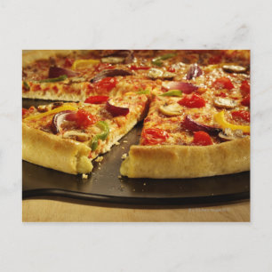 Vegetable pizza sliced on black pan on wood postcard