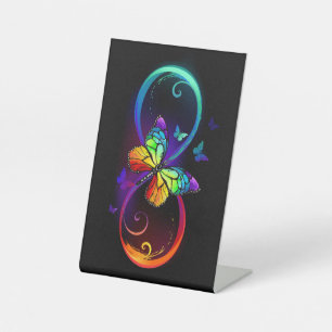 Vibrant infinity with rainbow butterfly on black pedestal sign
