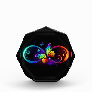 Vibrant infinity with rainbow butterfly on black photo block