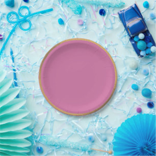 vibrant pink background with a golden rim paper plate