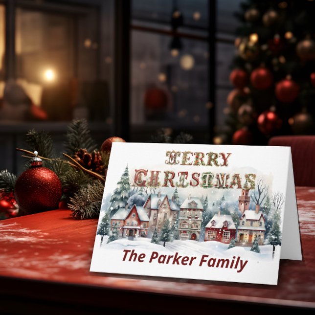 Victorian Village Merry Christmas  Card (A Christmas card stands on top of a table with Christmas elements in the background.)