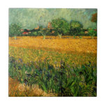 View of Arles with Irises by Vincent van Gogh Tile<br><div class="desc">View of Arles with Irises in the Foreground by Vincent van Gogh is a vintage fine art post impressionism landscape nature painting. A wheat field with purple iris flowers in the foreground on a farm. Trees and the town of Arles with houses are in the background. About the artist: Vincent...</div>