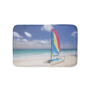View Of Beach With Sailboat Bath Mat