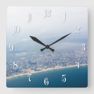 View on the seacoast through the aeroplane window square wall clock