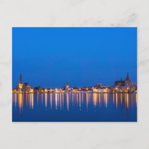 View to the city Rostock in Germany at night Postcard