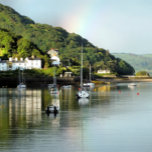 VIEWS OF WALES TEA TOWEL<br><div class="desc">After a day of rain,  the sun finally comes out and a rainbow appears in the sky,  in this beautiful landscape from Aberdyfi harbour in Wales,  with boats in the water and some of the village houses.</div>