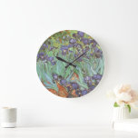 Vincent van Gogh - Irises Large Clock<br><div class="desc">Irises (1889) by Van Gogh is a vintage post impressionism fine art floral nature painting. A group of purple bearded irises and a single white iris flower growing in a garden. It was one of his first paintings while he was at the asylum in Saint-Remy-de-Provence. In 1987 it became the...</div>
