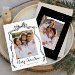 Vintage Black Bow Merry Christmas 2 Photo Holiday Card<br><div class="desc">Celebrate the holiday season with this charming Christmas card featuring your family's photo framed by a festive black bow and ribbon on a crisp white background. "Merry Christmas" is elegantly written in a charming black handwritten script, with space to personalise your family name below. The back of the card showcases...</div>