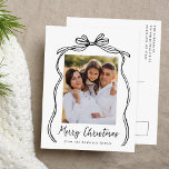 Vintage Black Bow Merry Christmas Photo Holiday Postcard<br><div class="desc">Celebrate the holiday season with this charming Christmas postcard featuring your family's photo framed by a festive black bow and ribbon on a crisp white background. "Merry Christmas" is elegantly written in a charming black handwritten script, with space to personalise your family name below. The back of the postcard displays...</div>