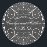 Vintage Black Chalkboard Flourish Wedding Monogram Classic Round Sticker<br><div class="desc">Decorative swirls and flourishes frame this elegant round vintage inspired wedding favour sticker design. Rustic black chalkboard textured background look with white design. Personalise the custom text with a monogram of the bride and groom names and wedding date.</div>