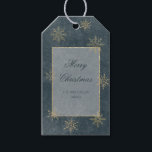 Vintage Blue & Gold Glitter Snowflakes Gift Tags<br><div class="desc">Against a backdrop of deep, mesmerising dark blue, reminiscent of the infinite expanse of the universe, this gift tag sets the stage for a truly magical look. The night sky is beautifully distressed with delicate white etchings, like ethereal constellations, while golden glittering snowflakes sprinkle across the canvas, adding a touch...</div>