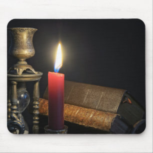Vintage books and hourglass on dark background mouse mat