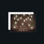 Vintage Bulbs Rustic Wood Botanical Wedding  RSVP Card<br><div class="desc">Wedding RSVP with vintage edison hanging lights decorated with botanical greenery over a rustic wood plank background.</div>