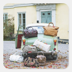 Vintage car with lots of luggage square sticker