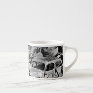 Vintage cars rusting away in a car yard espresso cup