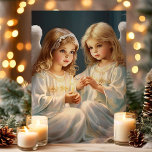 Vintage Christmas Angels with Candle Holiday Card<br><div class="desc">Send a heavenly greeting with our Vintage Christmas Angels with Candle Holiday Card! This beautiful card features a serene illustration of two angelic children holding a glowing candle, capturing the essence of peace and joy during the holiday season. Perfect for sharing warm wishes with friends and family, this card evokes...</div>