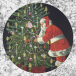 Vintage Christmas, Santa Claus with Presents Classic Round Sticker<br><div class="desc">Vintage illustration Merry Christmas holiday design featuring a jolly Santa Claus lighting candles on a decorated Christmas tree with wrapped gifts and presents underneath. Season's Greetings and Happy Holidays!!  Ho,  ho,  ho!</div>