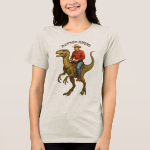 Vintage Cowboy Riding a Velociraptor Dinosaur URM Tri-Blend Shirt