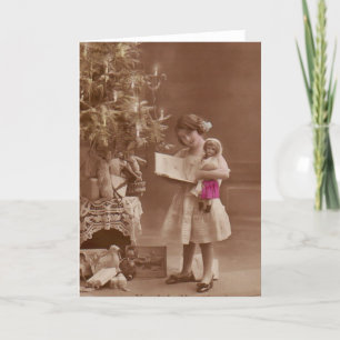 vintage girl with doll at christmas holiday card