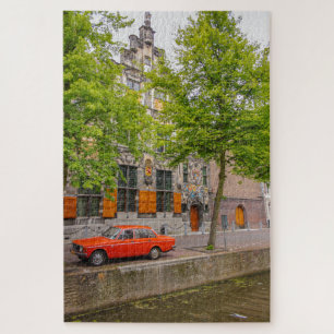 Vintage orange car along an Amsterdam canal Jigsaw Puzzle