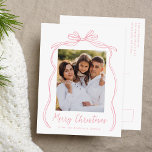 Vintage Pink Bow Merry Christmas Photo Holiday Postcard<br><div class="desc">Celebrate the holiday season with this charming Christmas postcard featuring your family's photo framed by a festive pink bow and ribbon on a crisp white background. "Merry Christmas" is elegantly written in a charming pink handwritten script, with space to personalise your family name below. The back of the postcard displays...</div>