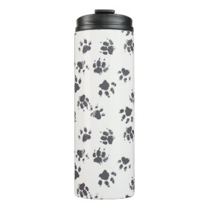 vintage seamless pattern with paw footprints of a thermal tumbler