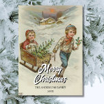 Vintage Winter Sleigh Ride with Christmas Tree Holiday Card<br><div class="desc">This nostalgic Christmas card shows a cheerful winter scene by E. A. Schwerdtfeger: a boy pulling a sleigh with a girl holding a Christmas tree. The snow-covered ground, the childlike joy, and the festive evergreen capture the true spirit of Christmas. It is a heartwarming image of family, tradition, and holiday...</div>