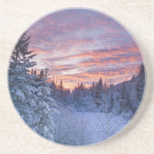Vivid sunset paints the sky above wintery coaster