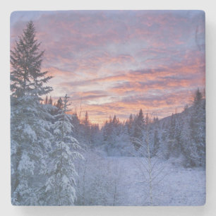 Vivid sunset paints the sky above wintery stone coaster