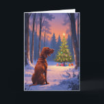 Vizsla Gazing at Christmas Tree in Snowy Forest Card<br><div class="desc">A heartwarming atmospheric artwork featuring a rusty red Vizsla with floppy ears and a sleek coat, sitting at the edge of a serene snowy forest clearing. Tall trees with snow-laden branches surround a glowing Christmas tree adorned with colourful ornaments and soft fairy lights, under a twilight sky painted in warm...</div>