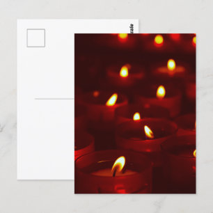 Votive candles burning in vigil postcard