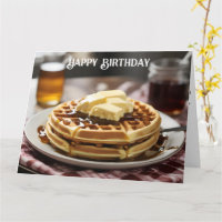 Waffles on plate with syrup and button ontop