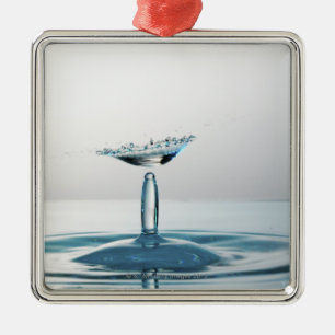 Water drops colliding to shape an umbrella metal tree decoration