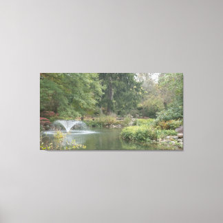 Water fountain in garden pond canvas print