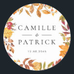 Watercolor Autumn Leaves Wreath Wedding Classic Round Sticker<br><div class="desc">This fall wedding sticker features a delicate watercolor garland of autumn leaves in warm, earthy shades like rust, amber, and olive green. Perfect for sealing envelopes, decorating favour bags, or adding a personal touch to packaging, this sticker can be customised with your names and wedding date. The design blends beautifully...</div>