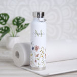 Watercolor Wildflowers Boho Stylish with Monogram Water Bottle<br><div class="desc">A stylish water bottle with its feminine boho wildflowers design and personalised with your monogram initial and name. It features a border row of watercolor wildflowers in soft pastel hues of pink, periwinkle blue, off-white and yellow with delicate stems and greenery. A text template is included to personalise with your...</div>
