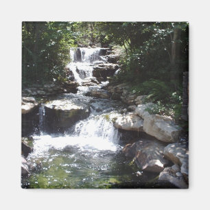 Waterfall streams over rocks into calm pool magnet